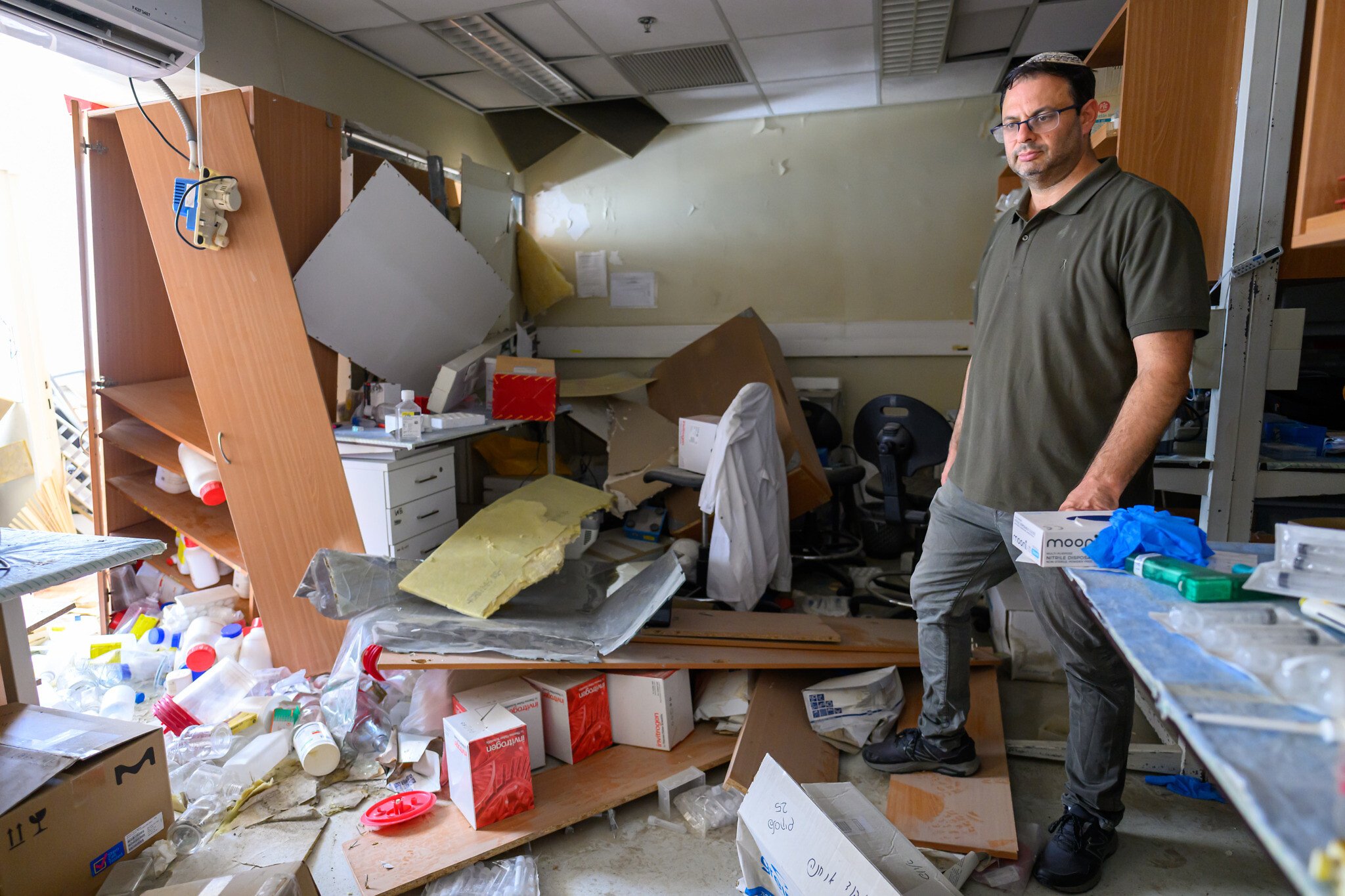 Prof. Ehud Ohana surveys his lab in the Department of Clinical Biochemistry and Pharmacology at Ben-Gurion University of the Negev, destroyed by the June 19, 2025, Iranian ballistic missile strike, on June 24, 2025. (Courtesy/Dani Machlis)